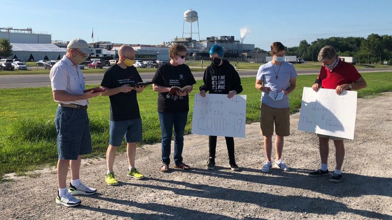 Members of the deacon formation class in the Diocese of Davenport, Iowa, pray along with other Catholics and family members across the road from the Tyson Foods plant in Columbus Junction, Iowa, July 24, 2020, for workers who have died of COVID-19. (CNS photo/courtesy The Catholic Messenger)