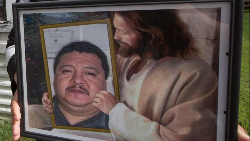 Enedelia Martinez holds a picture of her partner, Raul Castaneda, who died of COVID-19 in April, at their Shoreview, Minn., home July 20, 2020. Experts and those who minister to immigrant communities say fears about finances and the threat of deportation may be keeping some who are ill from seeking testing and treatment for the coronavirus. (CNS photo/Dave Hrbacek, The Catholic Spirit)