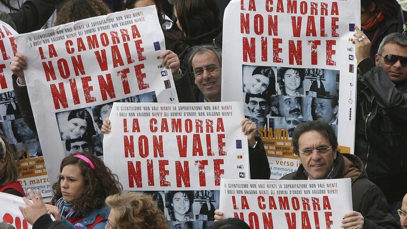 Demonstrators are pictured in a file photo holding banners during a demonstration in Naples, Italy, to commemorate the victims of the mafia and demand an end to the stranglehold of organized crime on southern Italy. (CNS photo/Ciro De Luca, Reuters)