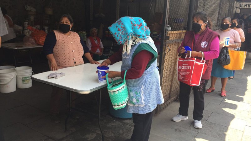 People wait to receive free meals outside Our Lady of the Assumption Church in Mexico City Aug. 17, 2020. The COVID-19 pandemic hit Mexico hard, and priests say many more people than usual need food aid. (CNS photo/David Agren)