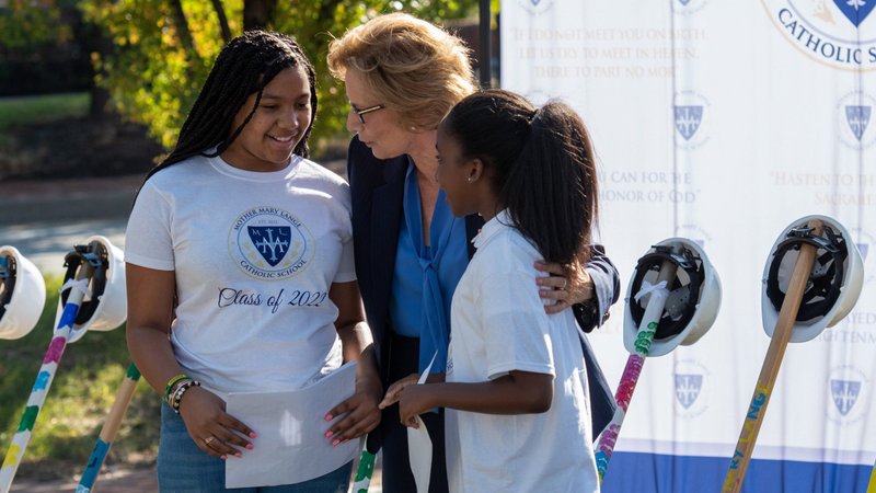 Donna Hargens, superintendent of Catholic Schools for the Archdiocese of Baltimore, congratulates Ss. James and John Catholic School student Breanna Ervin, left, and Holy Angels Catholic School student, Jaylah Golder, following their remarks at the Oct. 23, 2019 groundbreaking of the Mother Mary Lange Catholic School in Baltimore. (CNS photo/Kevin J. Parks, Catholic Review)