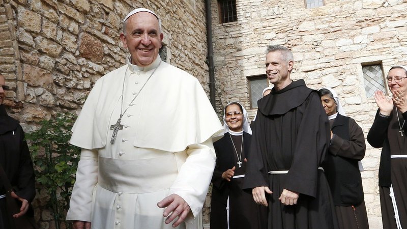 Pope Francis greets religious as he leaves the hermitage and cell of St. Francis in Assisi, Italy, in this Oct. 4, 2013, file photo. The pope plans to visit Assisi on Oct. 3 to celebrate a private Mass and sign his new encyclical on human fraternity. (CNS photo/Paul Haring)