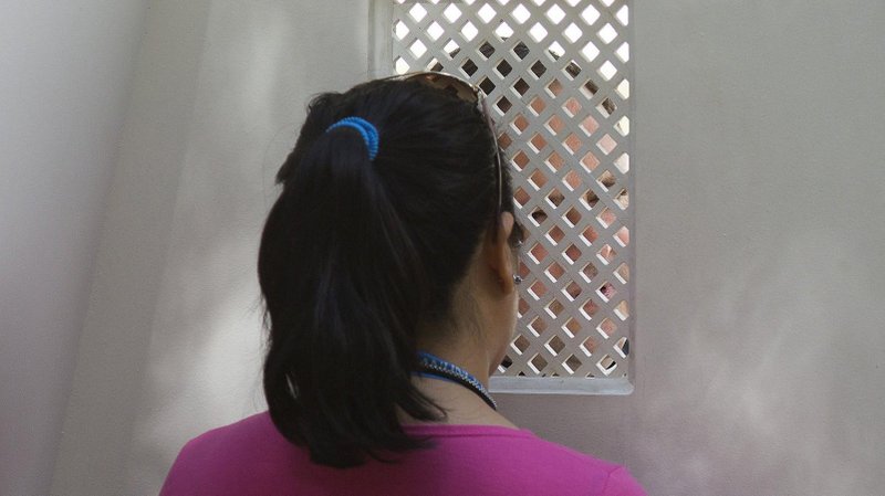 A young woman is pictured in a file photo during confession. New laws passed by Queensland Parliament in Australia Sept. 8, 2020, mean religious institutions and their members are no longer able to use the seal of the confessional as a defense or excuse in child sex abuse matters. (CNS photo/Tyler Orsburn)