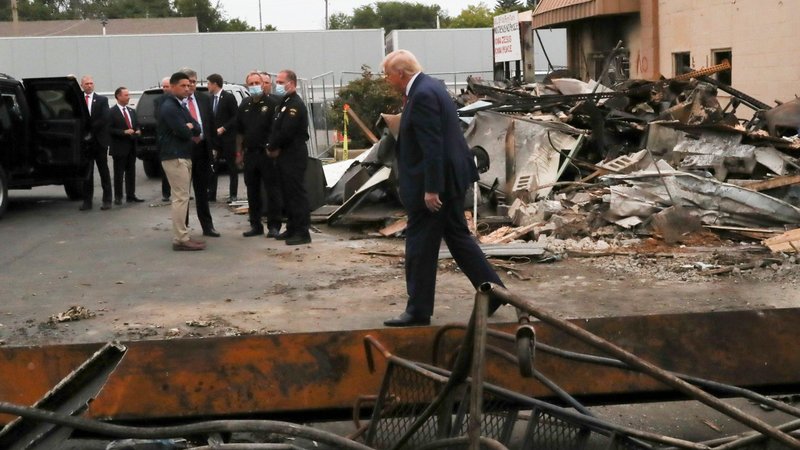 President Donald Trump examines property damage while visiting Kenosha, Wis., Sept. 1, 2020, in the aftermath of recent protests against police brutality and racial injustice. Jacob Blake, a Black man, was shot by a white police officer there seven times in the back Aug. 24 while entering his car with his three small children inside the vehicle. (CNS photo/Leah Millis, Reuters)