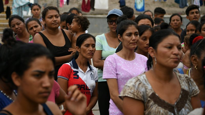Migrants line up for a free meal provided by volunteers at a makeshift encampment near the U.S. port of entry at the Gateway International Bridge in Matamoros, Mexico, Aug. 24, 2019. (CNS photo/Loren Elliott, Reuters)
