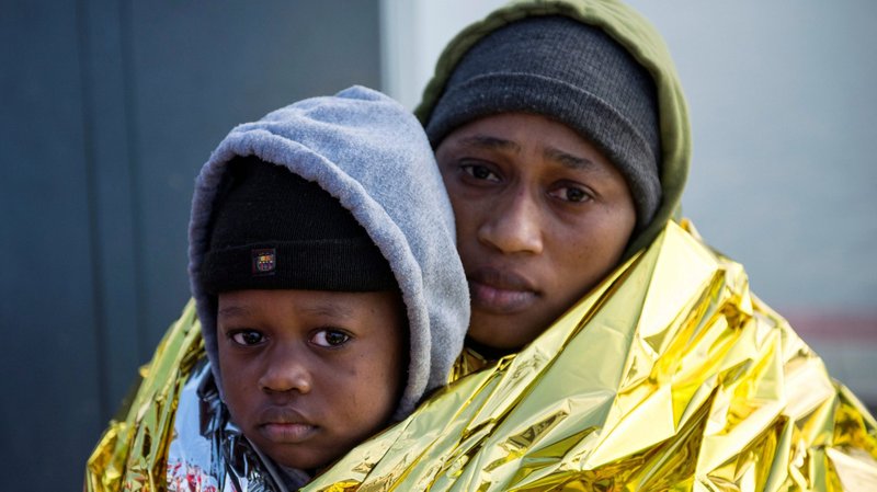 Migrants are seen in a file photo resting at a port in Melilla, Spain, after being rescued by the Spanish Coast Guard on the Chafarinas Islands in the Mediterranean Sea. (CNS photo/Jesus Blasco de Avellaneda, Reuters)