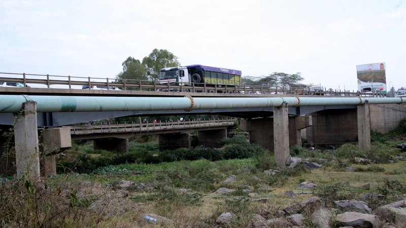 A truck travels over a bridge above a pipeline along the Athi River area near Nairobi, Kenya, Sept. 10, 2020. A similar oil pipeline in Uganda and Tanzania is being resisted over concerns that it will harm the people, environment and wildlife. (CNS photo/Fredrick Nzwili)