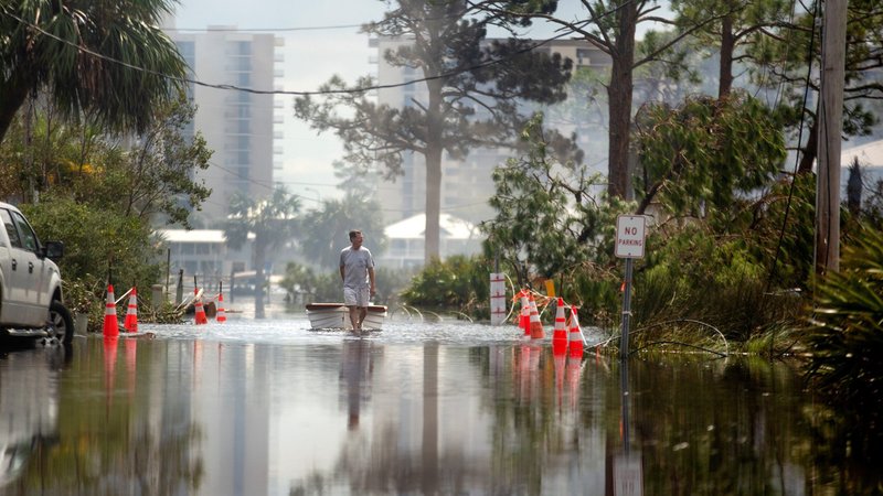 A man in Perdido Key, Fla., pulls his boat through a flooded street Sept. 17, 2020, after Hurricane Sally swept through the area. (CNS photo/Kathleen Flynn, Reuters)