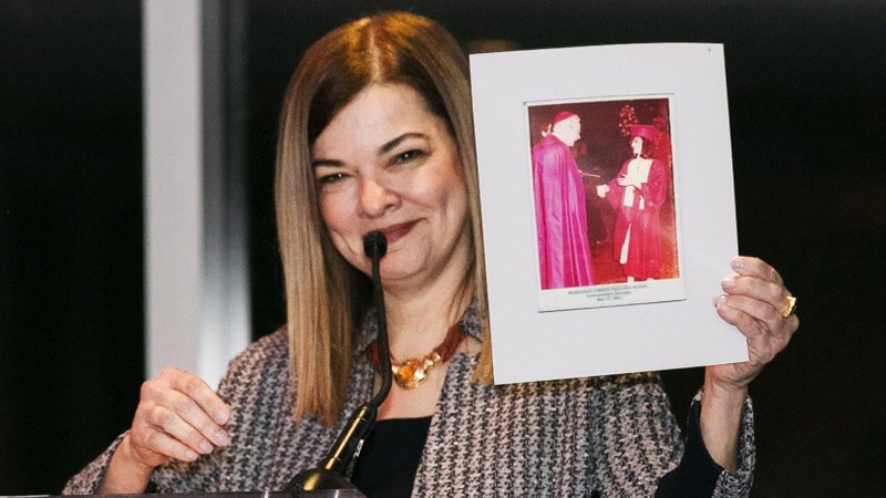 In this 2019 file photo, Justice Barbara Lagoa holds up a picture of Miami's second archbishop, Edward McCarthy, presenting her with her high school diploma. She was the first Hispanic woman to be appointed as a justice of the Supreme Court of Florida and was named by President Donald Trump to the U.S. Court of Appeals for the 11th Circuit. A Catholic, she is on Trump's list of potential nominees to fill the U.S. Supreme Court seat left vacant by the Sept. 18, 2020, death of Associate Justice Ruth Bader Ginsburg. (CNS photo/Tom Tracy, Florida Catholic)