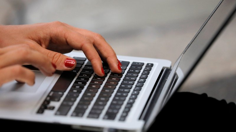 A woman uses a laptop in this illustration photo. (CNS photo/Andrew Kelly, Reuters)