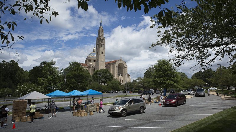 Catholic Charities staff and volunteers in the Archdiocese of Washington distribute 500 grocery boxes and 500 family meals in the parking lot of the Basilica of the National Shrine of the Immaculate Conception July 10, 2020, during the coronavirus pandemic. (CNS photo/Tyler Orsburn)