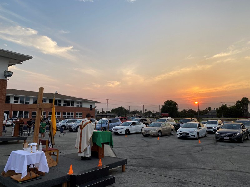 Families from St. Pius X-St. Matthias Academy attend a drive-in Mass Aug. 21 marking the feast day of the school's patron, St. Pope Pius X, celebrated by Father Peter Saucedo from St. Helen's Church in South Gate. (Anthony Boulahoud)