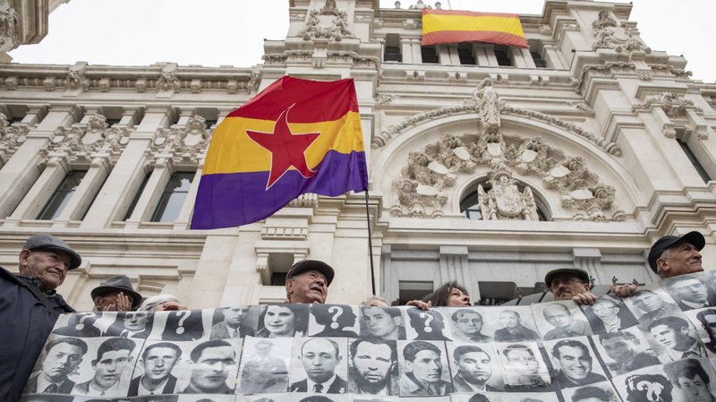 Dozens of protesters hold photos of the victims of Spain's former dictator, Gen. Francisco Franco, in front of the Madrid City Council building during a 2019 demonstration calling for the removal of the Almudena cemetery memorial, which they say is a reminder of the ruler. The Vatican released a statement July 21, 2020, distancing itself from any involvement in the Spanish government's decision to exhume Franco's remains, a divisive issue in that country. (CNS photo/David Jar, AlterPhotos/ABACAPRESS.COM via Reuters)