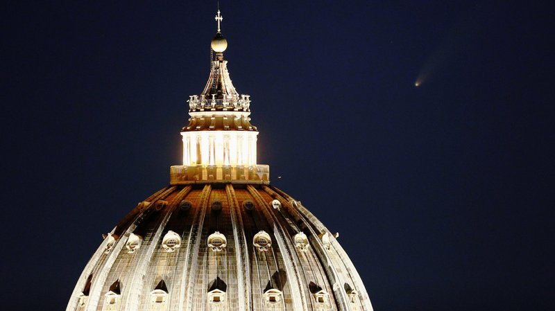 The comet "Neowise" is seen in the sky behind the dome of St. Peter's Basilica in Rome July 13, 2020. Church officials released the 2019 budget report Oct. 1. (CNS photo/Guglielmo Mangiapane, Reuters)