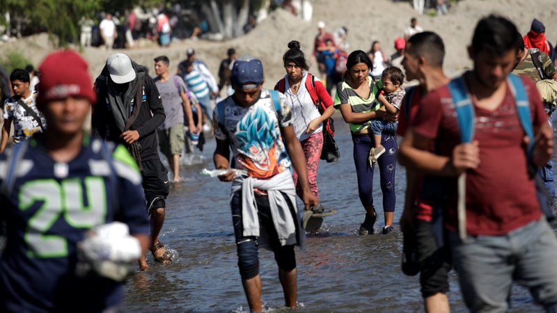 A caravan of migrants from Central America trying to reach the United States is seen in late January crossing a river near Ciudad Hidalgo, Mexico. Catholic migrant ministries in Guatemala are attending to a caravan of about 3,000 migrants who entered Guatemala Oct. 1 after setting out the night before from San Pedro Sula, Honduras. (CNS photo/Andres Martinez Casares, Reuters)