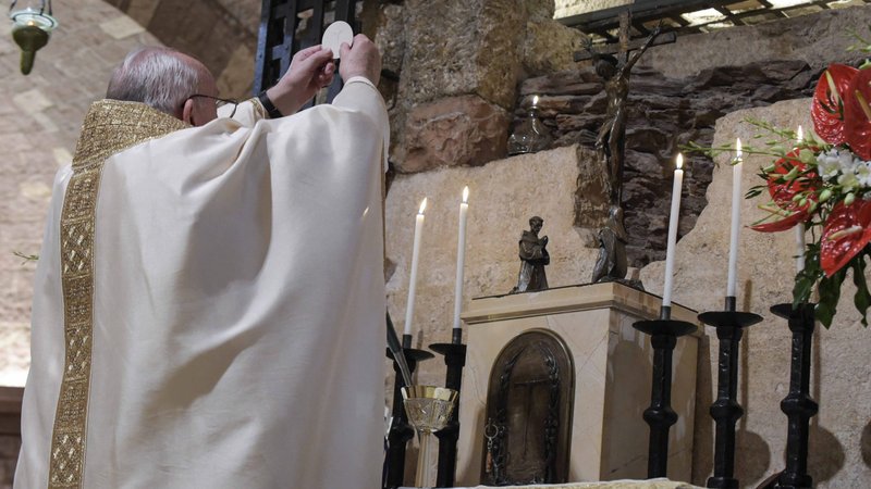 Pope Francis celebrates the Eucharist at the tomb of St. Francis in the crypt of the Basilica of St. Francis in Assisi, Italy, Oct. 3, 2020. The pope signed his new encyclical, "Fratelli Tutti, on Fraternity and Social Friendship," at the end of the Mass. (CNS photo/Vatican Media)