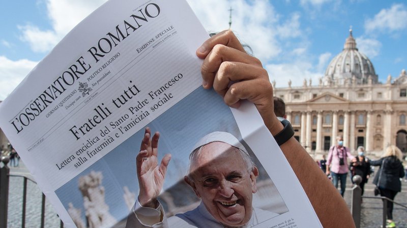 Free copies of L'Osservatore Romano, the Vatican newspaper, with the front page about Pope Francis' new encyclical, "Fratelli Tutti, on Fraternity and Social Friendship," are distributed by volunteers at the end of the Angelus in St. Peter's Square at the Vatican Oct. 4, 2020. (CNS photo/ IPA/Sipa USA, Reuters)