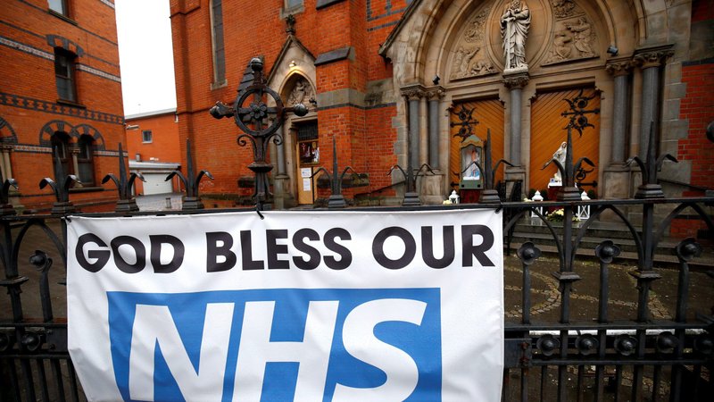 A banner in tribute to the National Health Service is pictured in a file photo outside the closed St. Paul's Catholic Church in Belfast, Northern Ireland, during the COVID-19 pandemic. Irish archbishops want to meet with Prime Minister Micheal Martin to discuss allowing people to return to Mass during the pandemic. (CNS photo/Jason Cairnduff, Reuters)