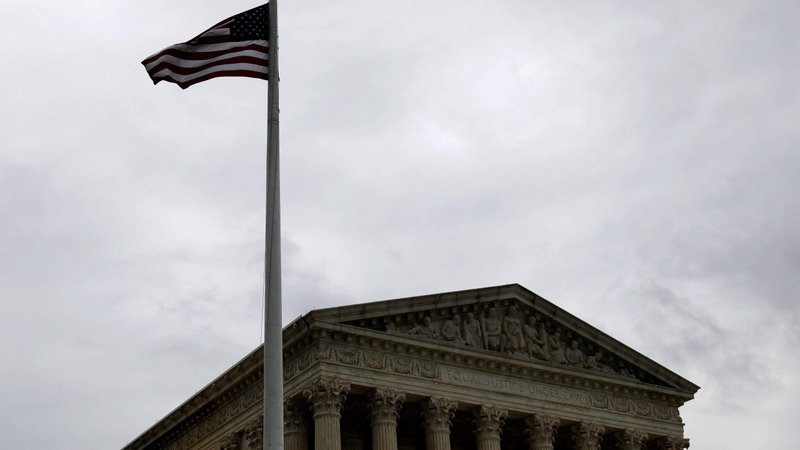 A flag flies in the wind next to the U.S. Supreme Court in Washington Aug. 29, 2020. (CNS photo/Andrew Kelly, Reuters)