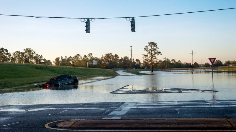 A submerged car in Lake Charles, La., is pictured on a flooded street Oct. 10, 2020, after Hurricane Delta swept through the area. (CNS photo/Kathleen Flynn, Reuters)