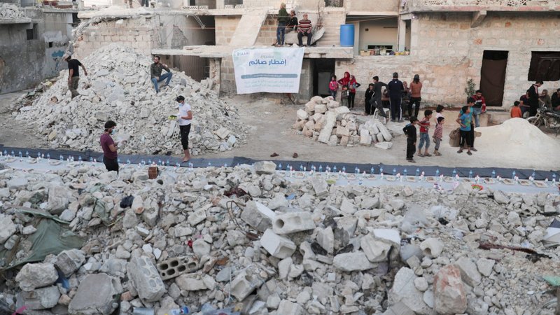Volunteers are seen in early May preparing meals in a damaged neighborhood in Aleppo, Syria. Ambassadors to the Vatican from around the world were called together Oct. 15, 2020, to hear from Cardinal Mario Zenari, apostolic nuncio to Syria, about the humanitarian disaster in Syria. (CNS photo/Khalil Ashawi, Reuters)