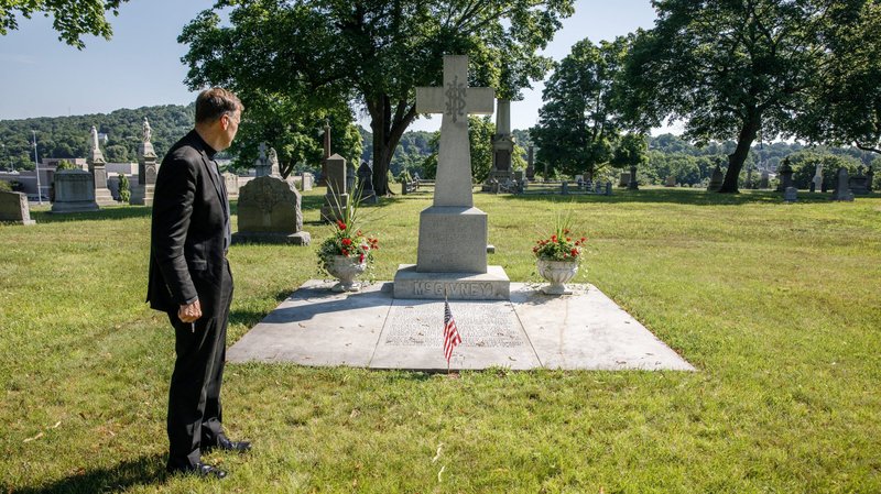 Father James Sullivan, rector of the Basilica of the Immaculate Conception in Waterbury, Conn., stands at the McGivney family grave site in the Old St. Joseph Cemetery in Waterbury July 6, 2020. Father Michael J. McGivney -- who was buried there for 92 years until his body was moved to St. Mary's Church in New Haven, Conn. -- will be beatified Oct. 31 during a Mass at the Cathedral of St. Joseph in Hartford, Conn. (CNS photo/Aaron Joseph, courtesy Archdiocese of Hartford)