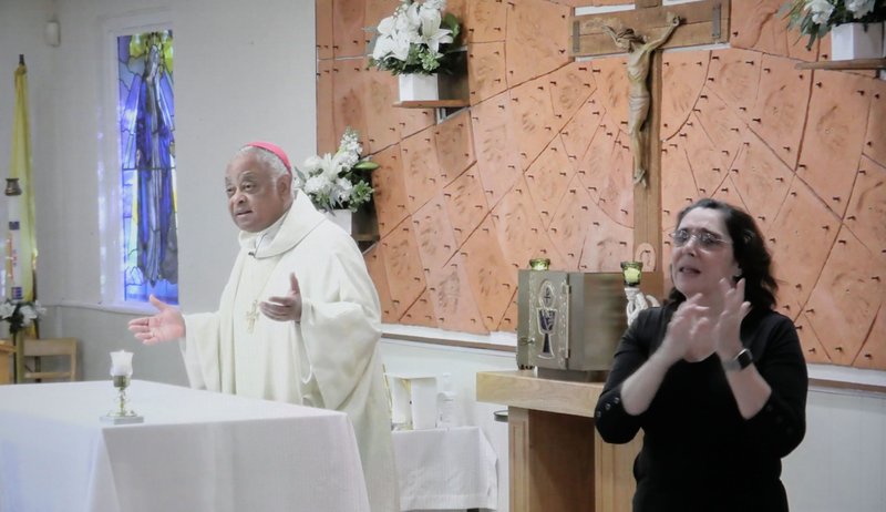 Washington Archbishop Wilton D. Gregory celebrates the White Mass at St. Francis Deaf Catholic Church in Landover Hills, Md., Oct. 18, 2020. Mary O'Meara, director of the Archdiocese of Washington's Department of Special Needs Ministries, interpreted the Mass in American Sign Language. (CNS photo/Screen grab via Catholic Standard)