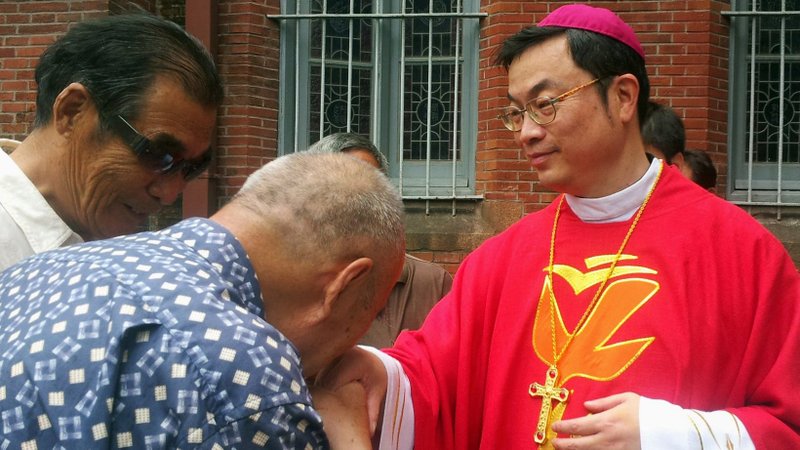 A well-wisher is pictured in a file photo kissing the ring of Bishop Thaddeus Ma Daqin following his episcopal ordination at St. Ignatius Cathedral in Shanghai. The Vatican and China have agreed to extend provisional agreement signed two years ago regarding the appointment of bishops. (CNS photo/courtesy of UCAnews)