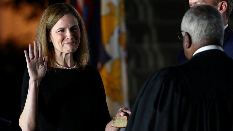 Judge Amy Coney Barrett holds her hand on the Bible as she is sworn in as an associate justice of the U.S. Supreme Court by Supreme Court Justice Clarence Thomas at the White House in Washington Oct. 26, 2020. (CNS photo/Tom Brenner, Reuters)
