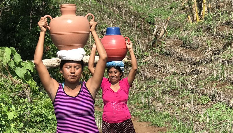 Women in Santa Catarina, El Salvador, carry water to their homes because their community water system doesn't work well. (Paul Hicks)