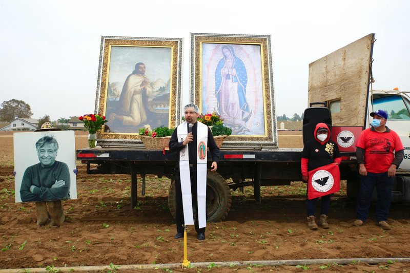 Father Juan Ochoa, pastor of Christ the King Church in Los Angeles and president of the Commission for Our Lady of Guadalupe, opens the procession of the images onto the field at Muranaka Farms. (David Amador Rivera/Angelus News)