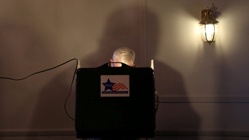 A voter in Chicago is seen behind a voting booth on Election Day Nov. 3, 2020. (CNS photo/Daniel Acker, Reuters)