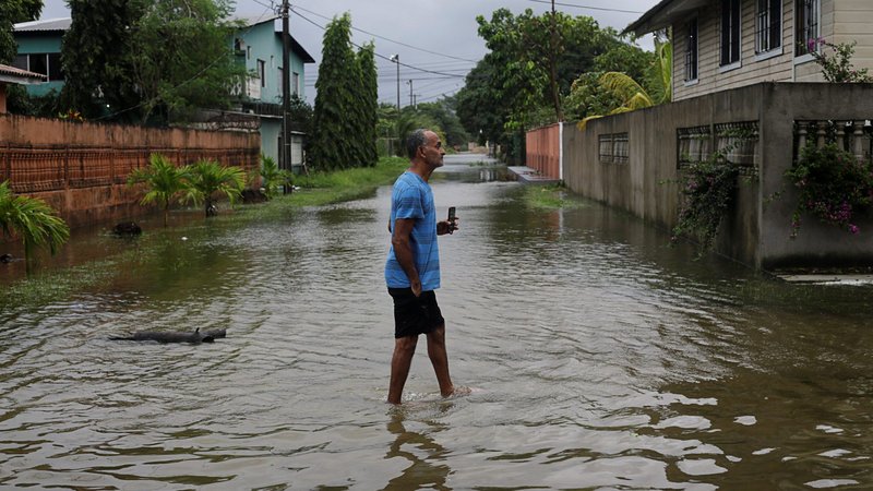 A resident walks through a flooded street as Hurricane Eta approaches Tela, Honduras, Nov. 3, 2020. (CNS photo/Jorge Cabrera, Reuters)