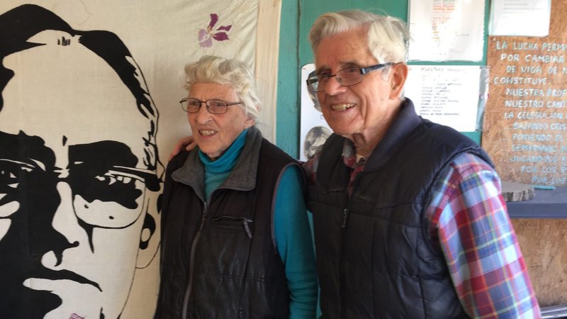 Mercy Sister Betty Campbell and Carmelite Father Peter Hinde pose next to an illustration of St. Oscar Romero in a 2019 photo in Ciudad Juarez, Mexico. Father Hinde and Sister Campbell will receive the CRISPAZ Peace Award Nov. 17 for their decades of ministry and social justice work in Latin America. (CNS photo/Julie Bourbon, courtesy Sisters of Mercy of the Americas)