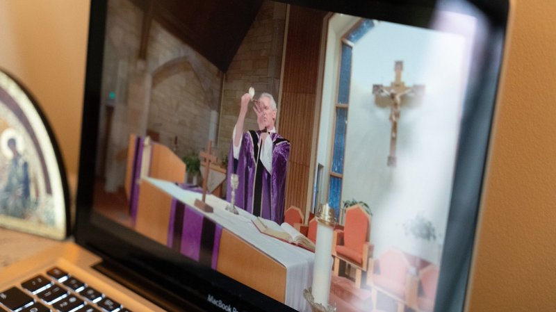 Mass is livestreamed on Facebook by Father Tom Kovatch, pastor of St. Charles Borromeo Catholic Church in Bloomington, Ind., March 28, 2020, during the pandemic. (CNS photo/Katie Rutter)