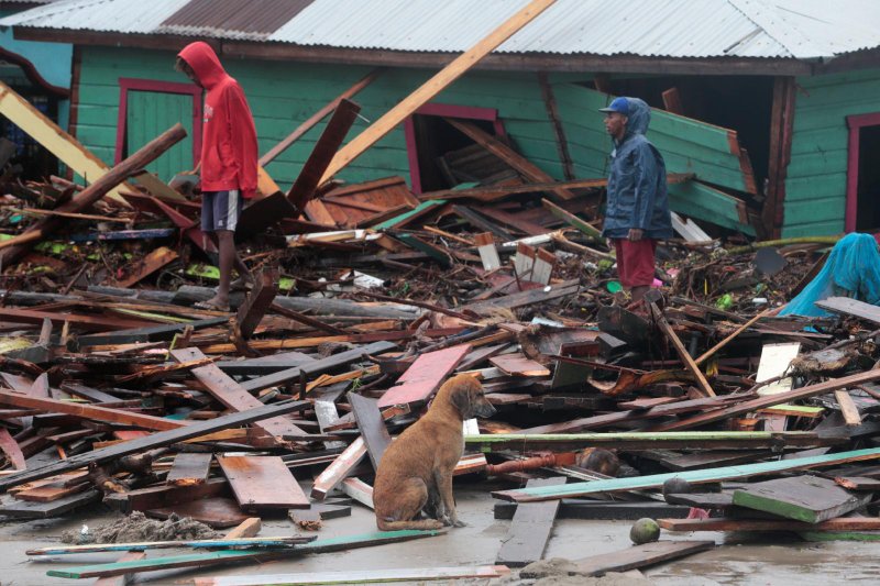Residents stand amid debris outside homes in Puerto Cabezas, Nicaragua, Nov. 17, 2020, in the aftermath of Hurricane Iota. The Category 4 storm hit the coast of Nicaragua near the border of Honduras Nov. 16, causing storm surges and flooding and further damaging buildings already wrecked by Hurricane Eta. (CNS photo/Oswaldo Rivas, Reuters)