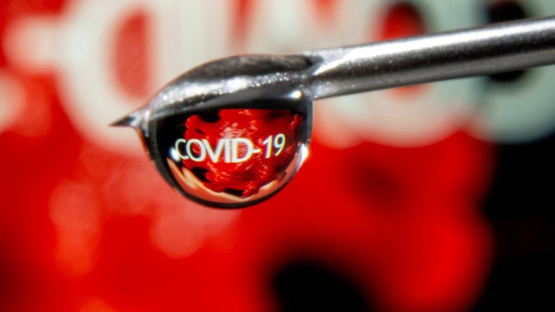 The word "COVID-19" is reflected in a vaccine drop that dangles from a syringe needle in this illustration photo Nov. 9, 2020. (CNS photo/Dado Ruvic, Reuters)