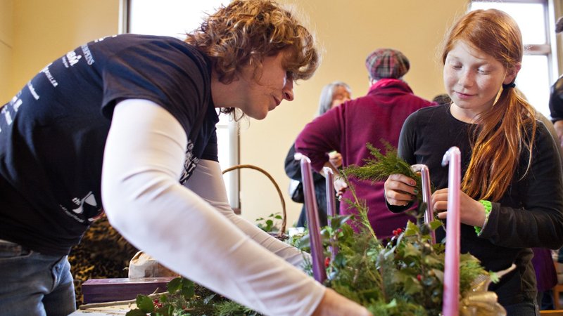 A woman and girl put the finishing touches on an Advent wreath in this 2013 file photo. (CNS/Tom McCarthy Jr., Catholic Review)