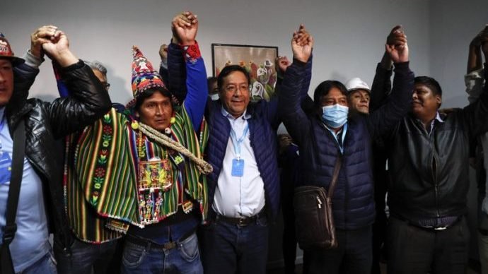 Luis Arce, center, Bolivian presidential candidate for the Movement Towards Socialism Party, MAS, and running mate David Choquehuanca, second right, celebrate during a press conference where they claim victory after general elections in La Paz, Bolivia, Monday, Oct. 19, 2020. (Juan Karita/AP via Crux)
