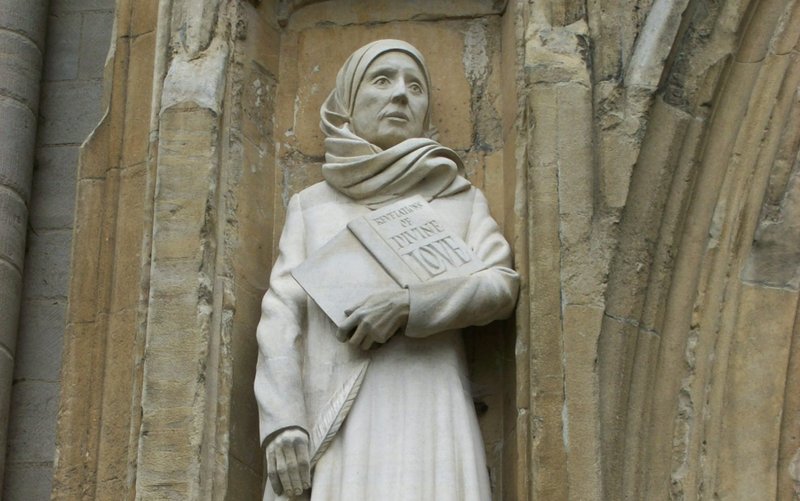 The statue of Julian of Norwich on the west front of Norwich Cathedral, in Norwich, Norfolk, England, made by the sculptor David Holgate in 2014. (Wikimedia Commons)