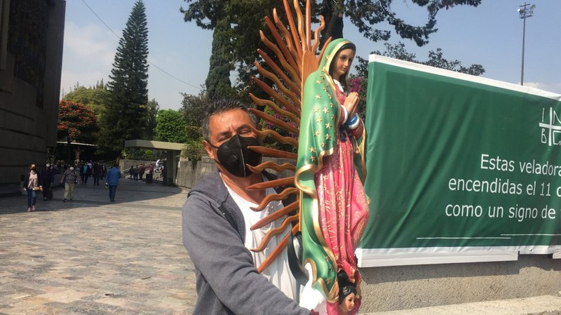 Carlos Melendez holds a statue of Our Lady of Guadalupe outside the basilica named for her in Mexico City Dec. 1, 2020. He arrived earlier than usual due to the basilica closing for the Dec. 12 feast day due to COVID-19. (CNS photo/David Agren)