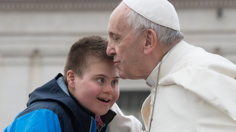 Pope Francis kisses Peter Lombardi, 12, of Columbus, Ohio, who has Down syndrome, after the boy rode in the popemobile during his general audience in St. Peter's Square at the Vatican March 28, 2018. (CNS photo/Vatican Media)