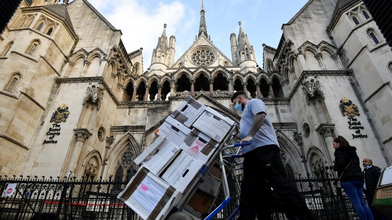 Officials deliver legal documents to the High Court in London Nov. 2, 2020. Bishop Philip Egan of Portsmouth and Catholic doctors welcomed the court ruling stopping children from accessing sex-change therapies. (CNS photo/Toby Melville, Reuters)