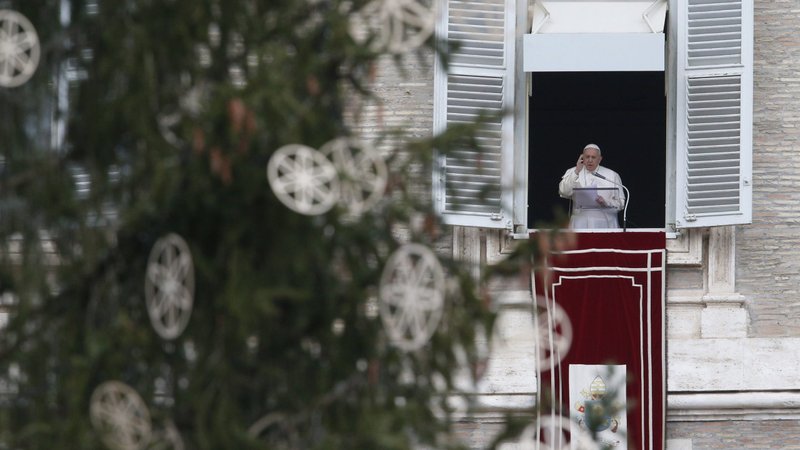 Pope Francis is framed by the Vatican Christmas tree as he delivers his blessing while leading the Angelus from the window of his studio overlooking St. Peter's Square at the Vatican Dec. 8, 2020, the feast of the Immaculate Conception. (CNS photo/Paul Haring)
