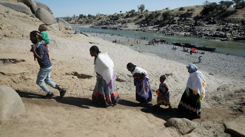 Ethiopians fleeing fighting in Ethiopia's Tigray region walk toward the Hamdeyat refugee transit camp in Sudan Dec. 1, 2020. (CNS photo/Baz Ratner, Reuters)