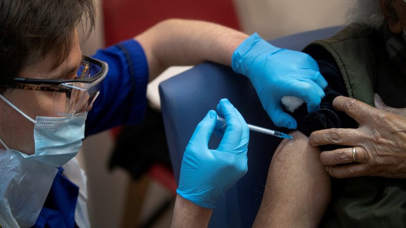 A man receives the first of two Pfizer/BioNTech COVID-19 vaccines at a hospital in London Dec. 8, 2020. (CNS photo/Victoria Jones pool via Reuters)