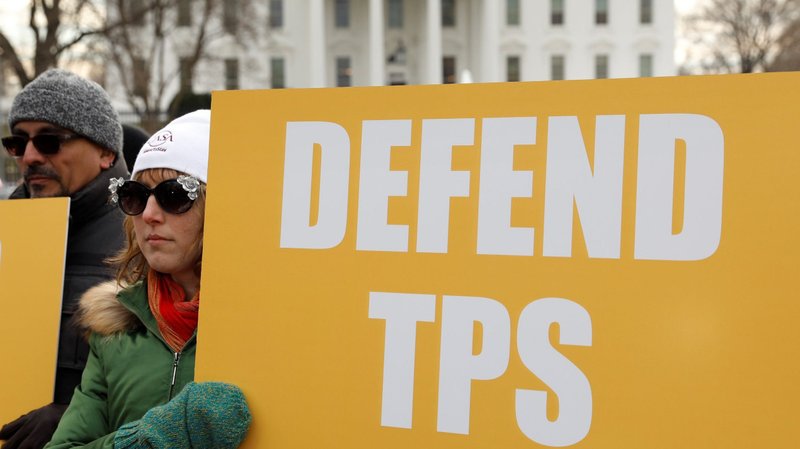Demonstrators hold signs Jan. 8, 2018, in front of the White House in Washington, calling for protecting the Temporary Protected Status program. (CNS photo/Kevin Lamarque, Reuters)