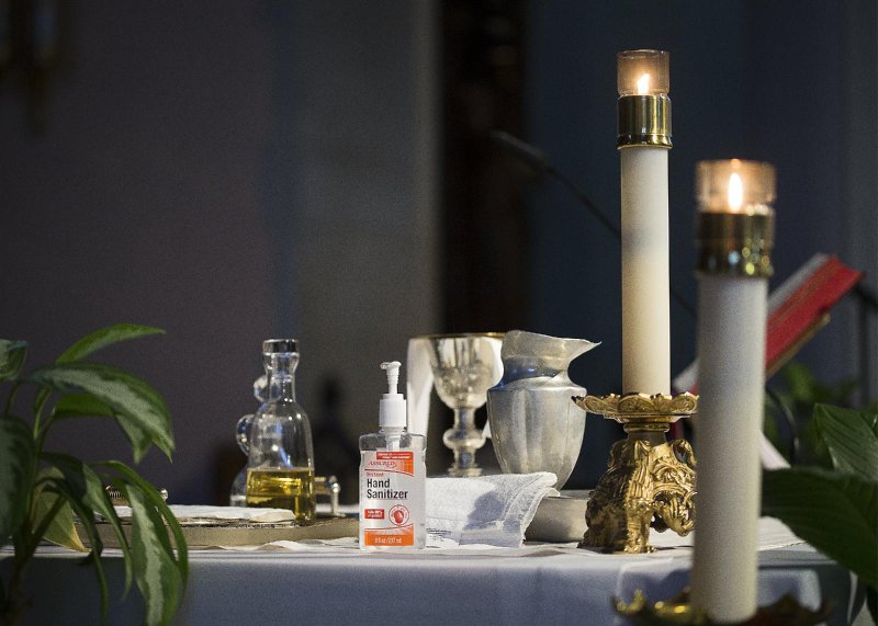 A bottle of hand sanitizer is seen on the altar prior to Mass at St. Gabriel Catholic Church in Washington July 11, 2020. (CNS photo/Tyler Orsburn)