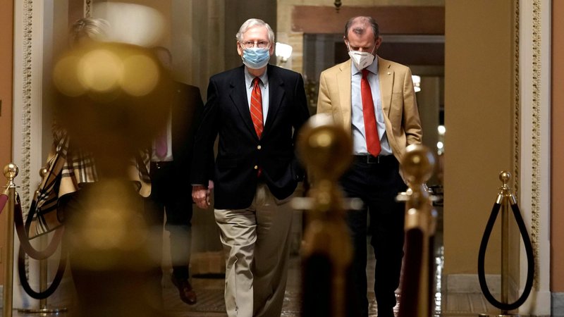 Senate Majority Leader Mitch McConnell, R-Ky., left, walks from his office to the Senate floor on Capitol Hill Washington Dec. 20, 2020. (CNS photo/Ken Cedeno, Reuters)