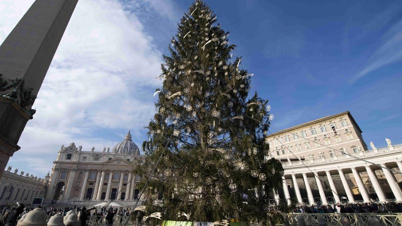 The Christmas tree is seen as Pope Francis leads the Angelus from the window of his studio overlooking St. Peter's Square at the Vatican Dec. 20, 2020. The pope said that current restrictions caused by the COVID-19 pandemic can help people put Christ, rather than the constant need to purchase gifts, at the center of the Christmas season. (CNS photo/Vatican Media)